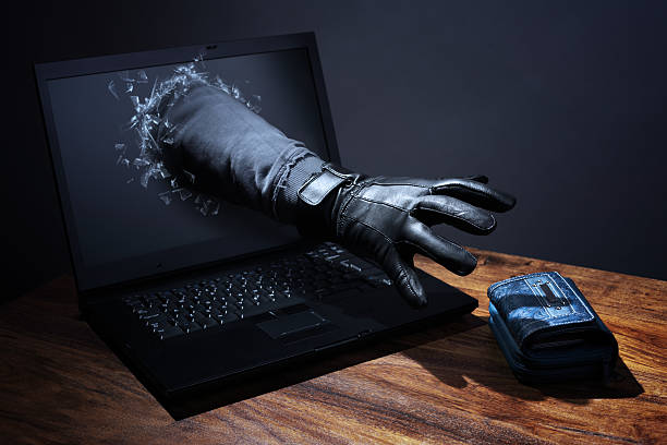 hand van hacker die uit het beeldscherm spullen gaat pakken van bureau