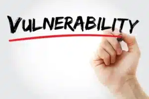 woord vulnerability in zwart met rode streep eronder