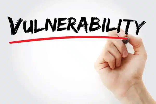 woord vulnerability in zwart met rode streep eronder